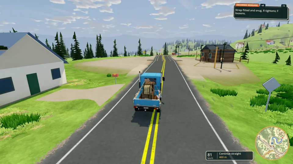 Driving a loaded truck past houses on a country road.