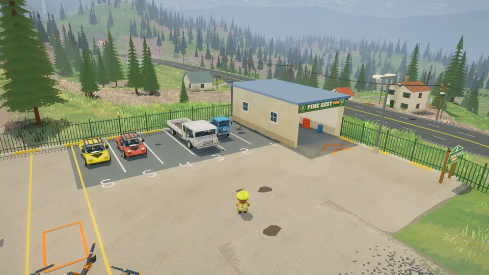 Aerial view of the depot yard with trucks, buildings and forest beyond.