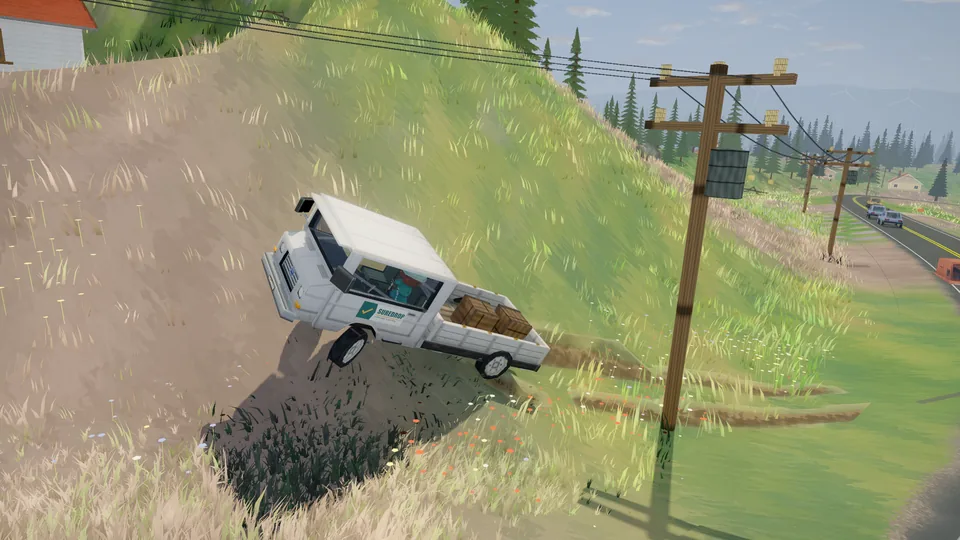 A truck on its side on a grassy verge after losing its load.